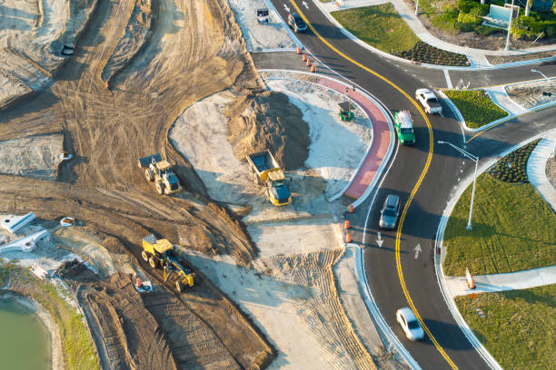 Aerial view of busy American highway road under construction. Development of roundabout traffic infrastructure. State transportation concept.
